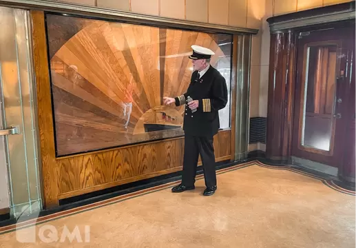 Commodore Everett discussing some of the rare woods aboard Queen Mary